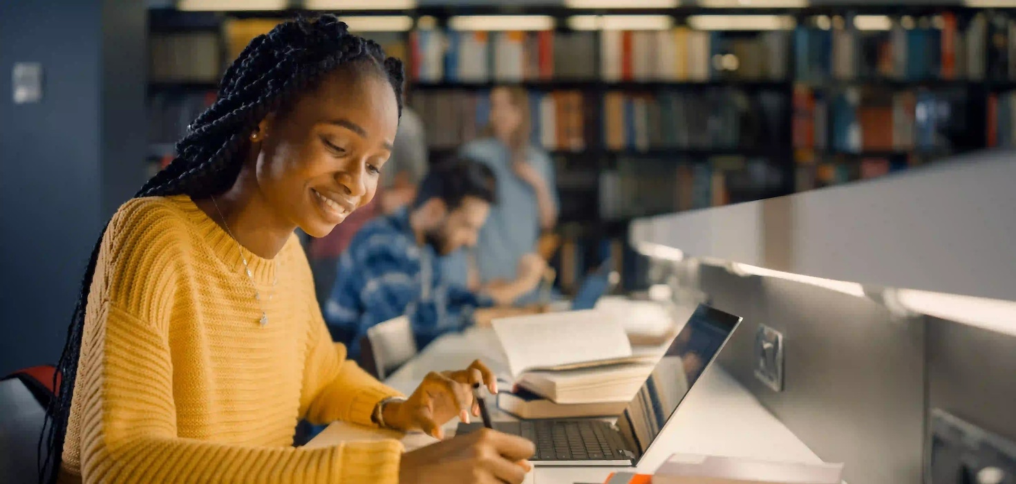 Happy college student working on homework