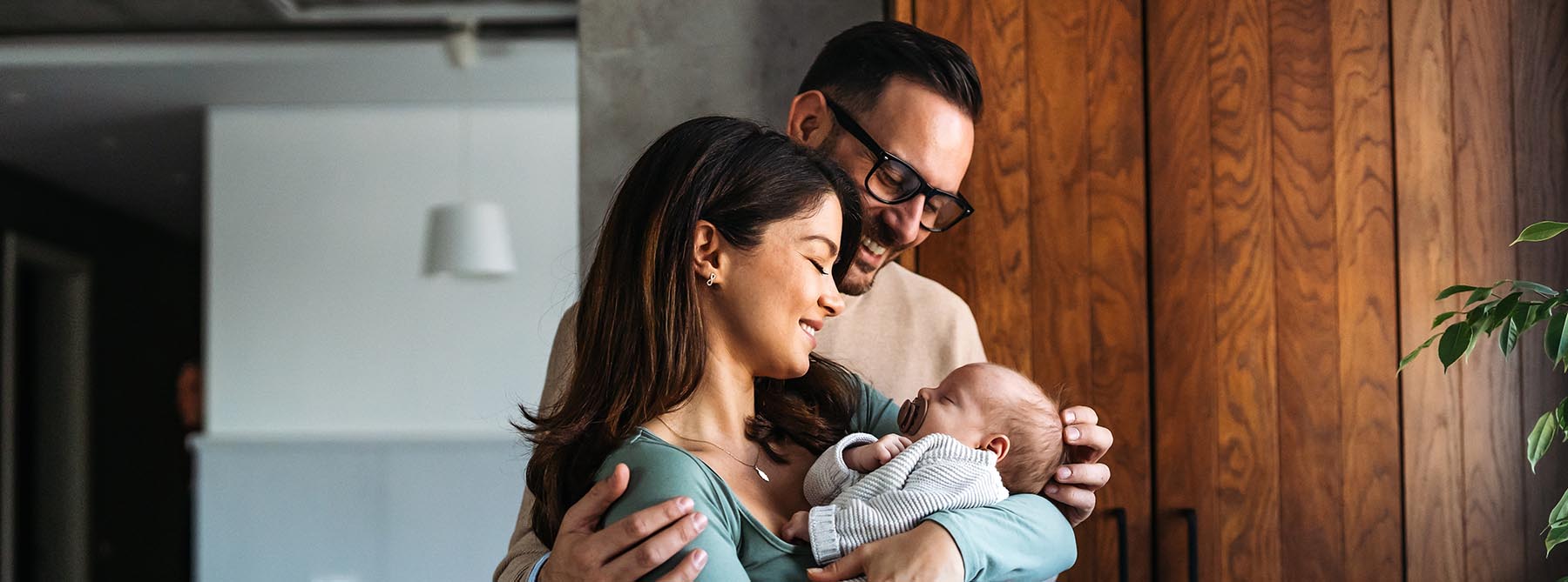 Happy couple holding baby