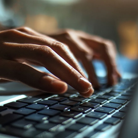 hands typing on keyboard