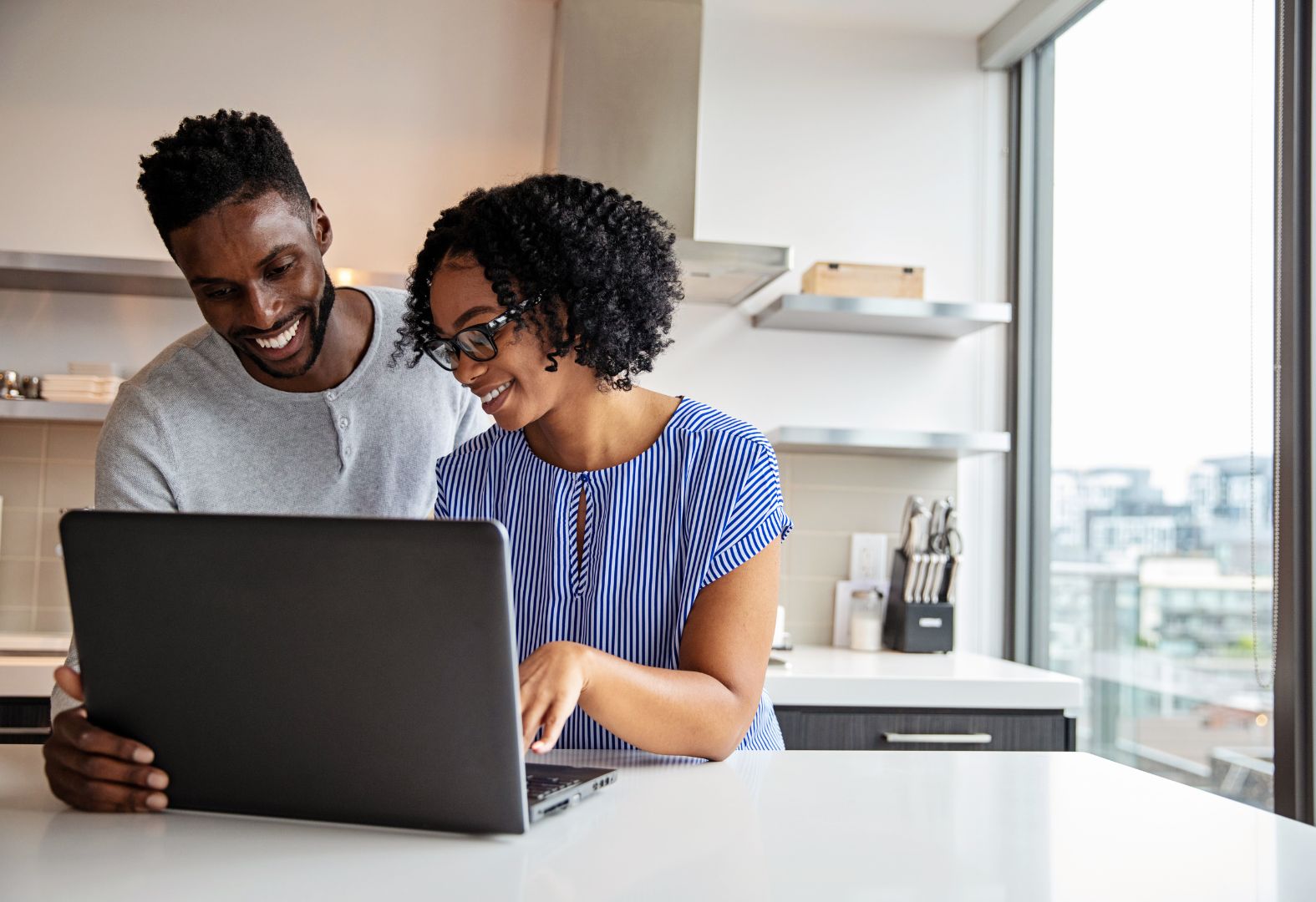 happy couple using laptop