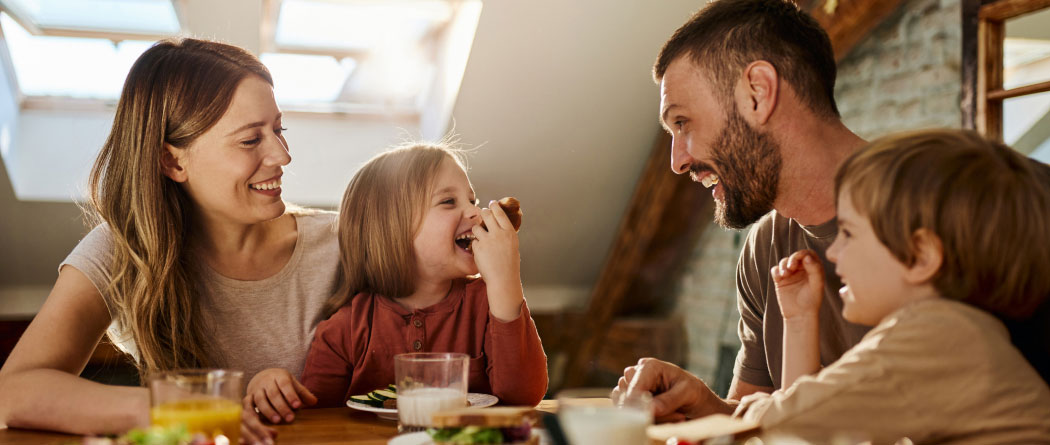 young family eating at a kitchen table